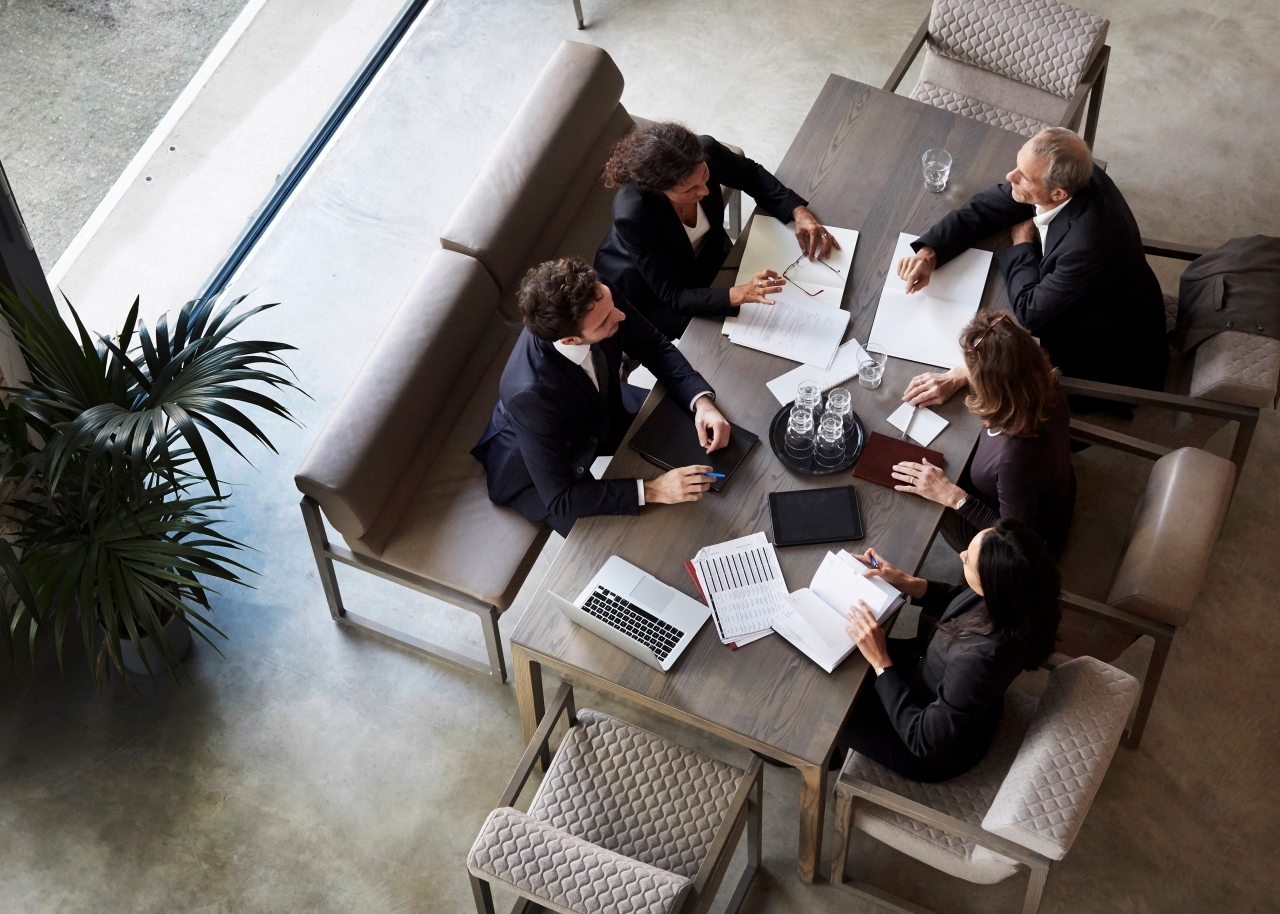 Team of business people planning with colleagues